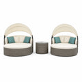 Ensemble de deux lits de jour et table ronde en résine tressée avec coussins et pare-soleil ajustable beige